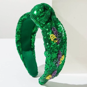 Macro shot of green sequin headband featuring handcrafted colorful beaded insect embroidery