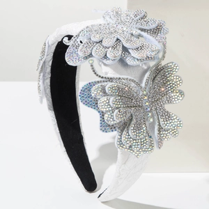 Close-up of luxury sponge headband with sparkling rhinestone butterflies and floral embroidery