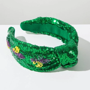 Detail of green sequin knotted headband with handmade purple and yellow floral beadwork