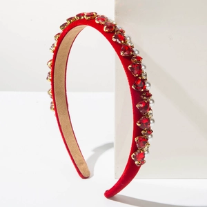 Detail of red velvet headband featuring inlaid heart gemstones and elegant white pearls