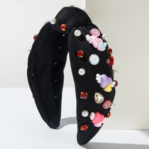 Detail of beaded headband with winged heart charms, pearls and red rhinestones