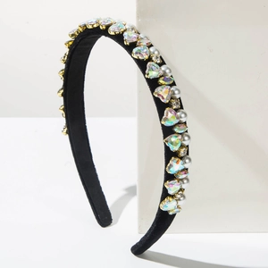 Detailed side view of black velvet headband with sparkling crystal hearts and pearls