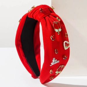 Red knotted wide headband with rhinestones, pearls, and a metal music charm