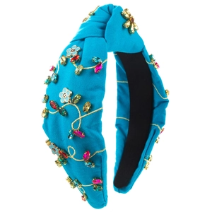 Close-up of royal blue knotted headband with colorful rhinestones and floral beadwork