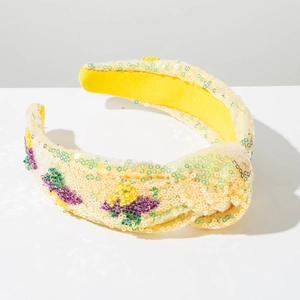 Macro shot of yellow sequined headband with purple bead floral details and twist knot