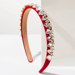 Detailed view of the red velvet headband featuring rhinestone hearts and white faux pearls