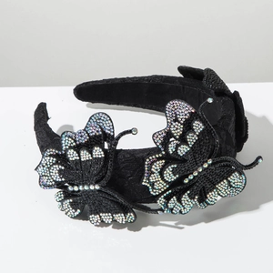 Detail view of black sponge headband with colorful rhinestone butterfly embellishments