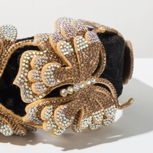 Macro shot of luxury headband featuring golden velvet butterfly with sparkling rhinestones
