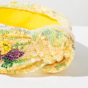 Macro detail of yellow sequin headband with colorful beads for carnival and parties