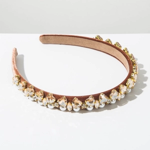 Detail of brown velvet headband with sparkling rhinestones and white faux pearls