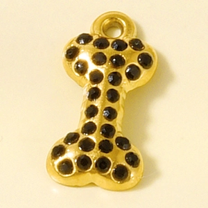 Detailed view of bone-shaped gold pendant with black rhinestones for DIY jewelry making