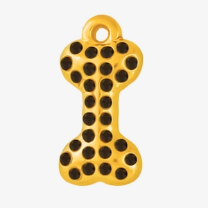 Detail of a gold bone pendant with black rhinestones and a hanging loop for DIY jewelry