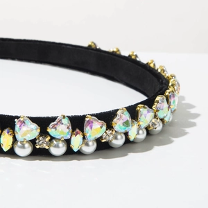 Detailed close-up of velvet headband featuring crystal hearts and white pearls