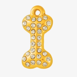 Macro view of gold-plated dog bone pendant with sparkling rhinestones and hanging hole