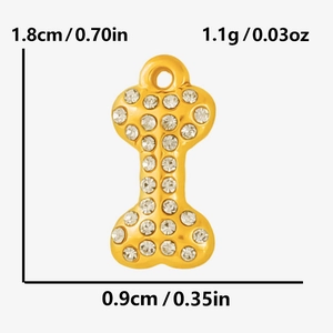 Macro detail of gold dog bone pendant with rhinestones and precise size measurements
