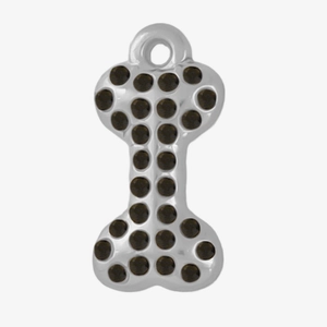 Detailed macro view of bone shaped stainless steel charm with brown rhinestones
