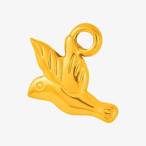 Macro view of a polished gold bird pendant with detailed wings and a jump ring connector