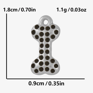 Macro view of stainless steel dog bone charm with black rhinestones and size details