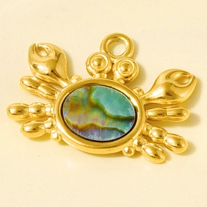 Vue macro du pendentif crabe en acier inoxydable 304 doré avec incrustation d'ormeau