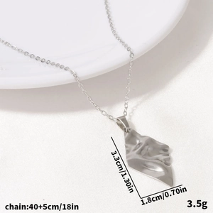Detail showing irregular geometric rhombus pendant in silver with precise dimensions