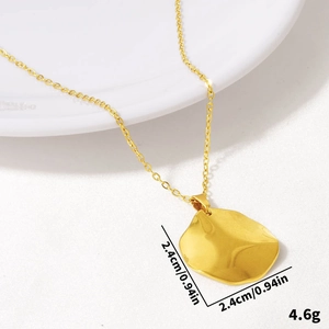 Dettaglio della collana in acciaio inossidabile dorato con ciondolo organico da 2,4cm