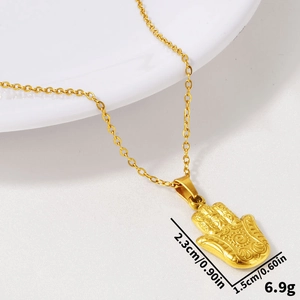 Detail of gold Hamsa hand pendant with embossed spiral texture on a fine chain