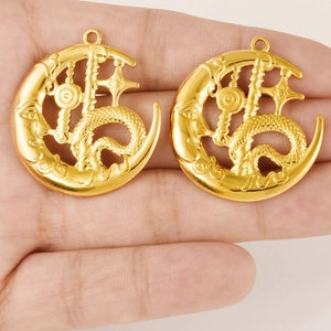 Pair of gold stainless steel moon and dragon pendants with intricate filigree cutouts