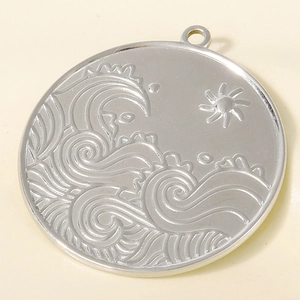 Detailed relief of sun and waves on a circular stainless steel pendant accessory