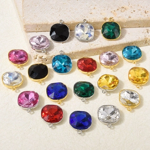Macro shot of colorful faceted glass pendants with gold-plated stainless steel edges