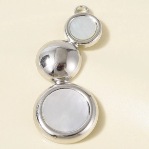Macro view of triple circular stainless steel pendant with iridescent abalone shell inlay