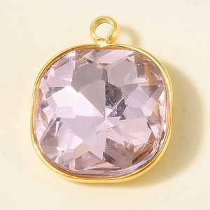 Macro shot of cushion cut pink crystal pendant with gold-plated stainless steel frame