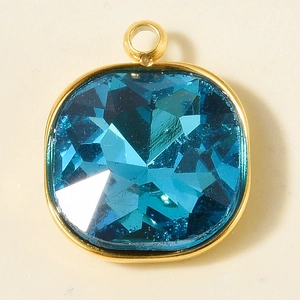 Detail of cushion cut blue crystal pendant with 18k gold-plated stainless steel frame