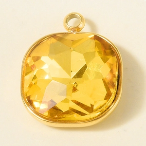 Macro shot of a square amber glass pendant with an 18k gold-plated 304 stainless steel frame