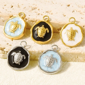 Macro detail of colorful sea turtle charms in gold and silver plating for DIY jewelry