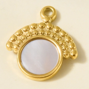Macro shot of 304 stainless steel gold pendant with white shell inlay and beaded edges