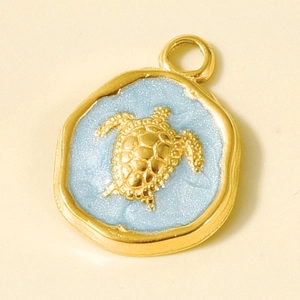 Macro shot of 304 stainless steel turtle pendant with light blue resin and golden edges