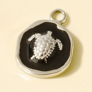 Macro shot of a sea turtle pendant made of 304 stainless steel with black enamel inlay