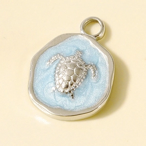 Detailed macro view of 304 stainless steel sea turtle pendant with blue enamel glitter