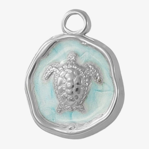 Macro shot of 304 stainless steel sea turtle pendant with blue enamel and textured edges
