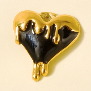 Detail of heart pendant with gold molten edges and black enamel drip effect for DIY jewelry