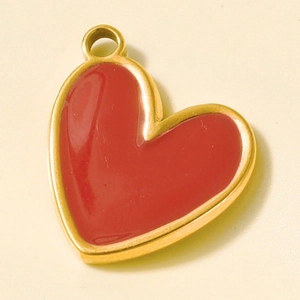 Detailed macro view of a red heart pendant with gold-tone edges for DIY jewelry crafts