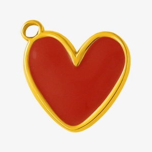 Macro detail of red enamel heart pendant with gold stainless steel edges for DIY