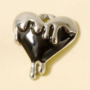 Macro detail of a 304 stainless steel heart pendant with lava drip effect and black enamel fill