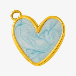 Detailed macro view of heart-shaped gold pendant with blue marble enamel finish