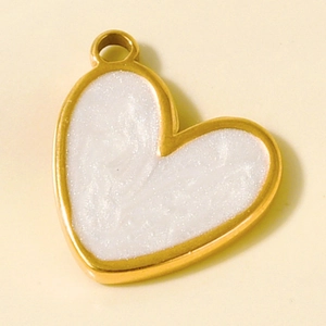 Macro detail of heart charm with gold edging and white pearlescent inlay for DIY jewelry