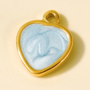 Detailed macro view of heart-shaped blue enamel pendant with gold-plated stainless steel edges