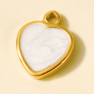 Detail of a 304 stainless steel heart pendant with gold plating and white pearlescent enamel