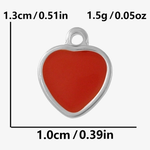 Detailed view of red enamel heart pendant with 1.3cm height and 1.0cm width dimensions