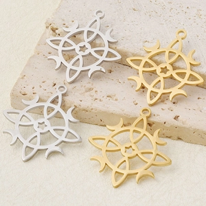 Detail showing laser-cut sun and moon pendants in gold and silver stainless steel