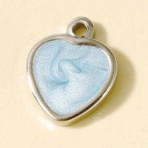 Macro shot of silver 304 stainless steel heart pendant with light blue glitter enamel inlay